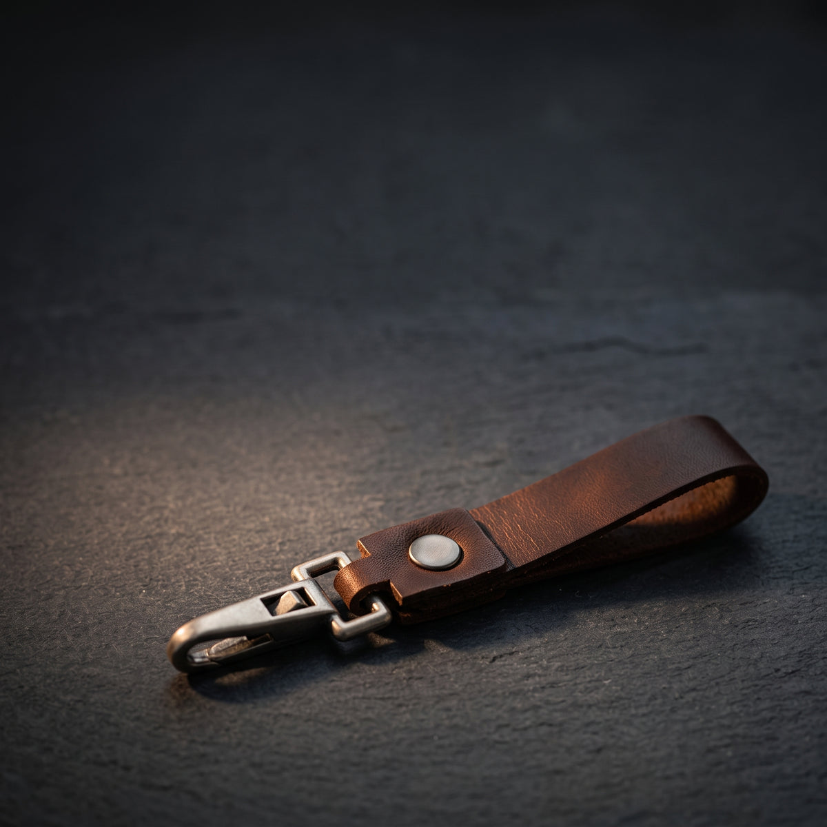 Brown leather keychain on dark slate - one of one leather